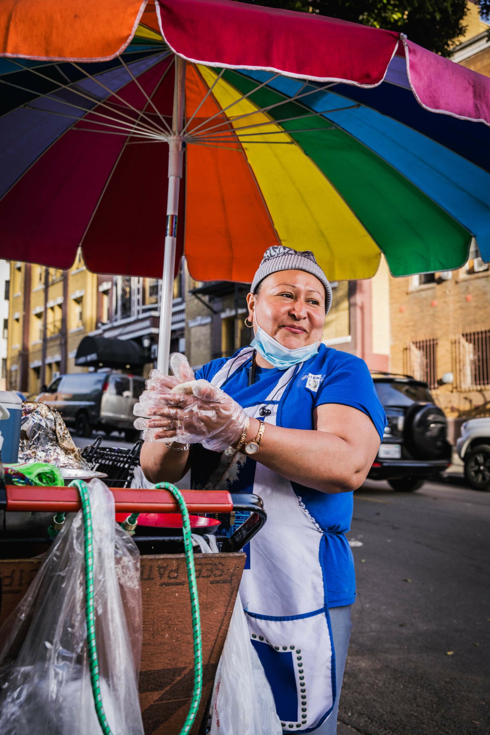 Street vendor preparing food on her cart in Los Angeles